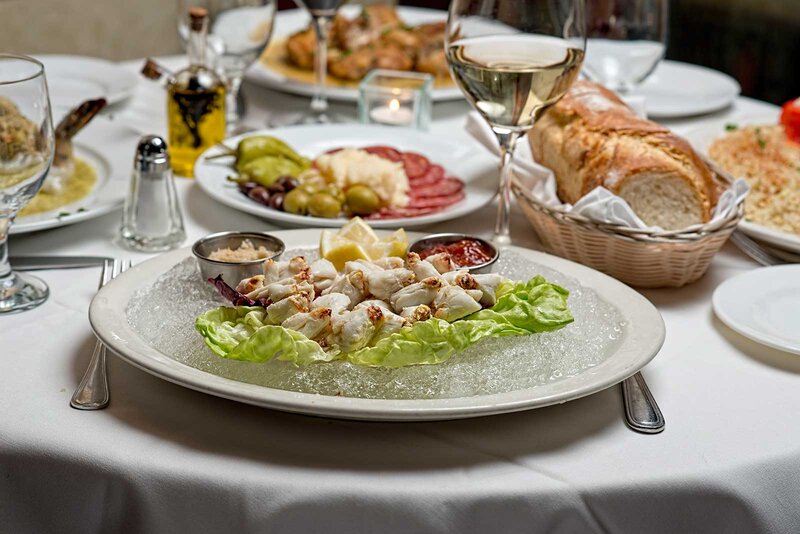 Seafood appetizer with glass of white wine