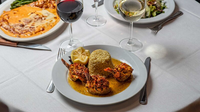 Jumbo shrimp served with rice in a garlic and herb sauce