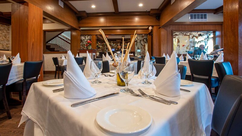 Dining room table set for four with breadsticks and olive oil